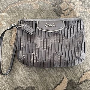 Used Coach wristlet. Dark gray. Pleated satin material
